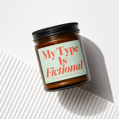 Amber jar candle with a label reading "My Type Is Fictional".