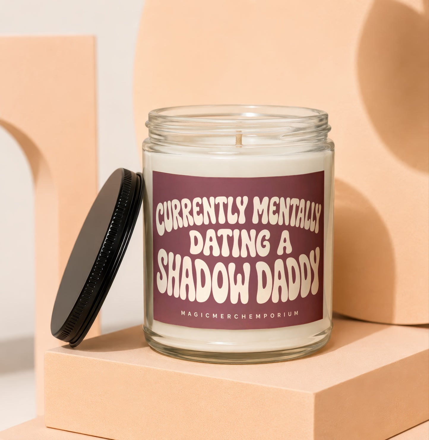 Glass jar candle with a maroon label reading "Currently Mentally Dating a Shadow Daddy."