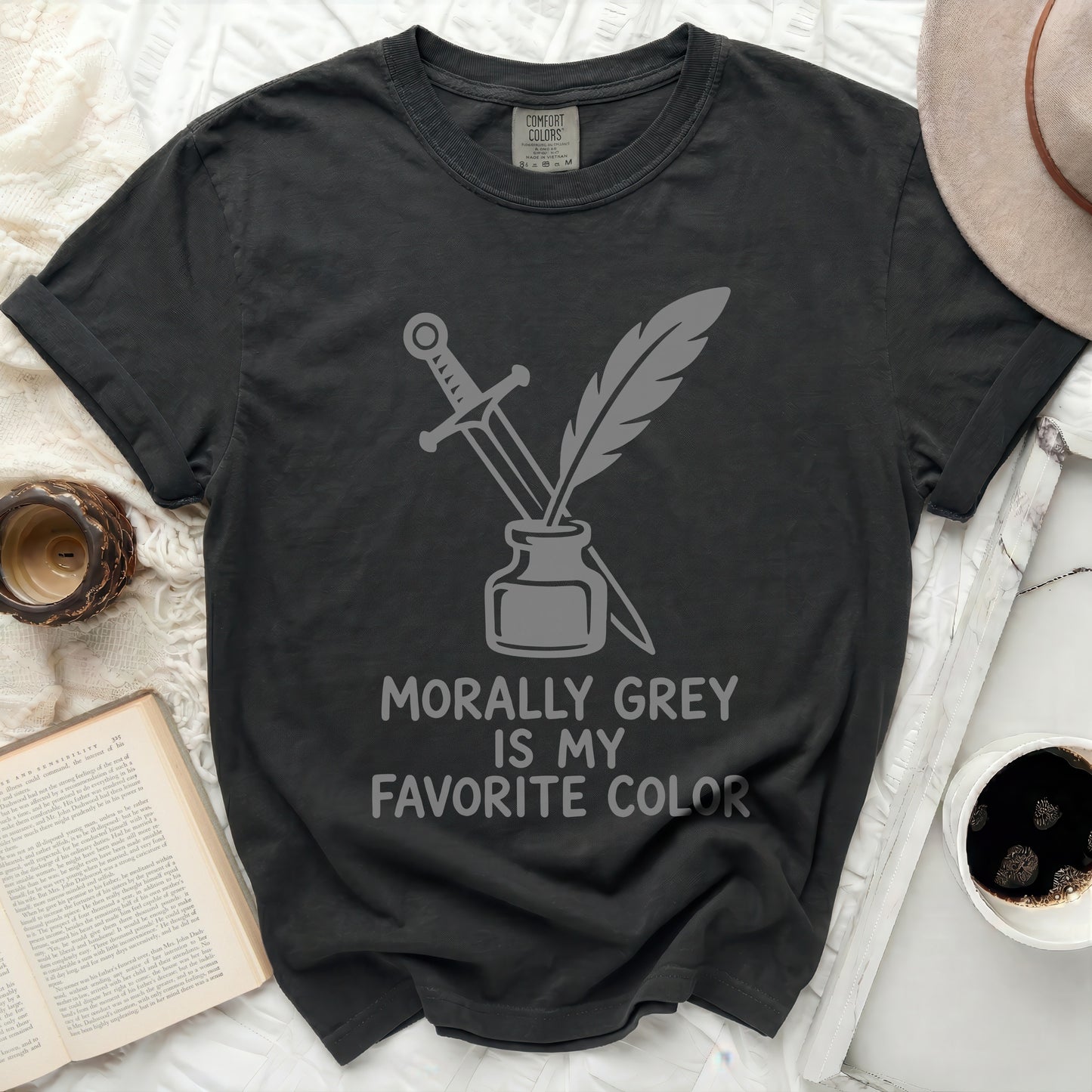 Dark grey t-shirt with sword, quill, and inkwell graphic and text.