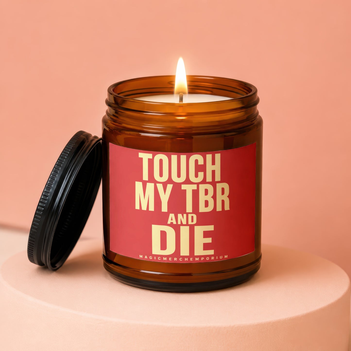 Amber jar candle with lit flame, black lid, and text "TOUCH MY TBR AND DIE"