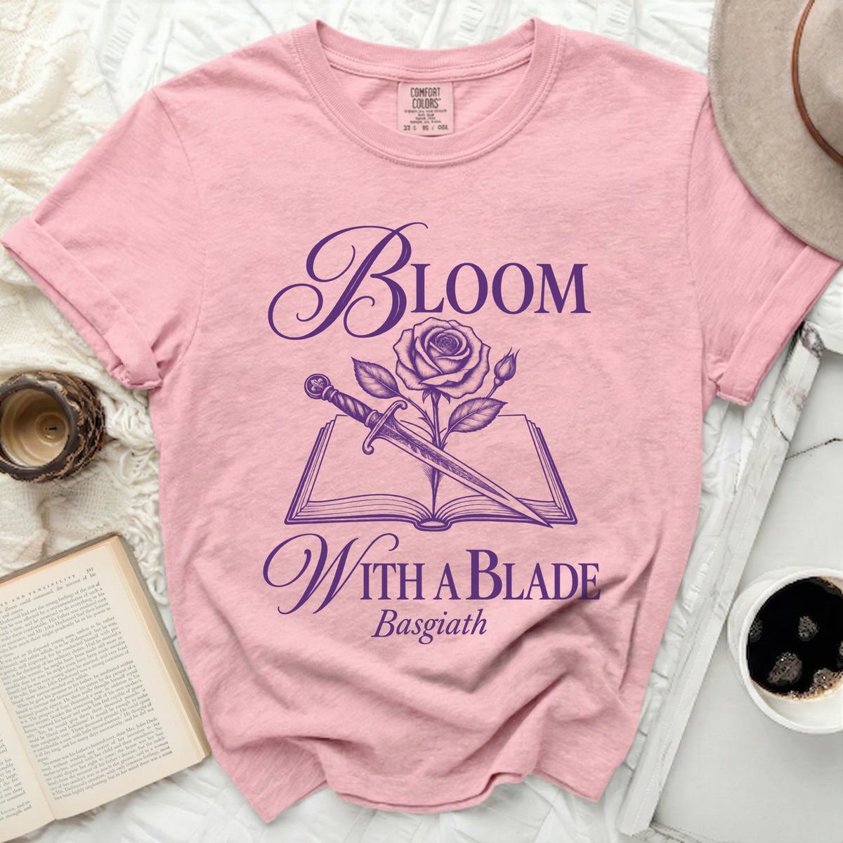 Pink t-shirt with "Bloom With A Blade Basgiath" text and floral sword design.