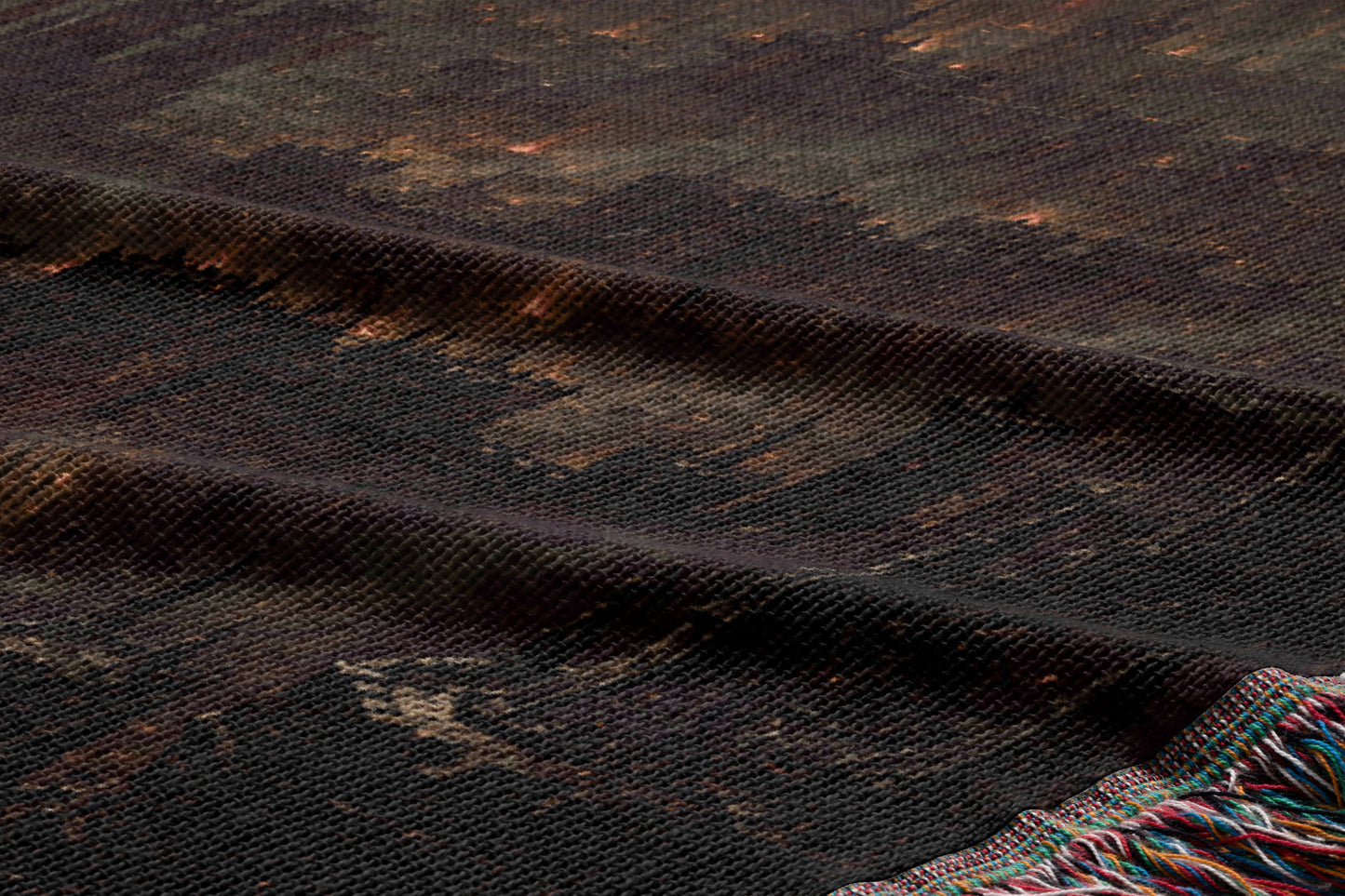 a close-up view of a dark, textured fabric with a pattern resembling a city skyline. The fabric appears to be made of a woven material, with a dark brown or black color. The image does not contain any text or other discernible objects or actions.