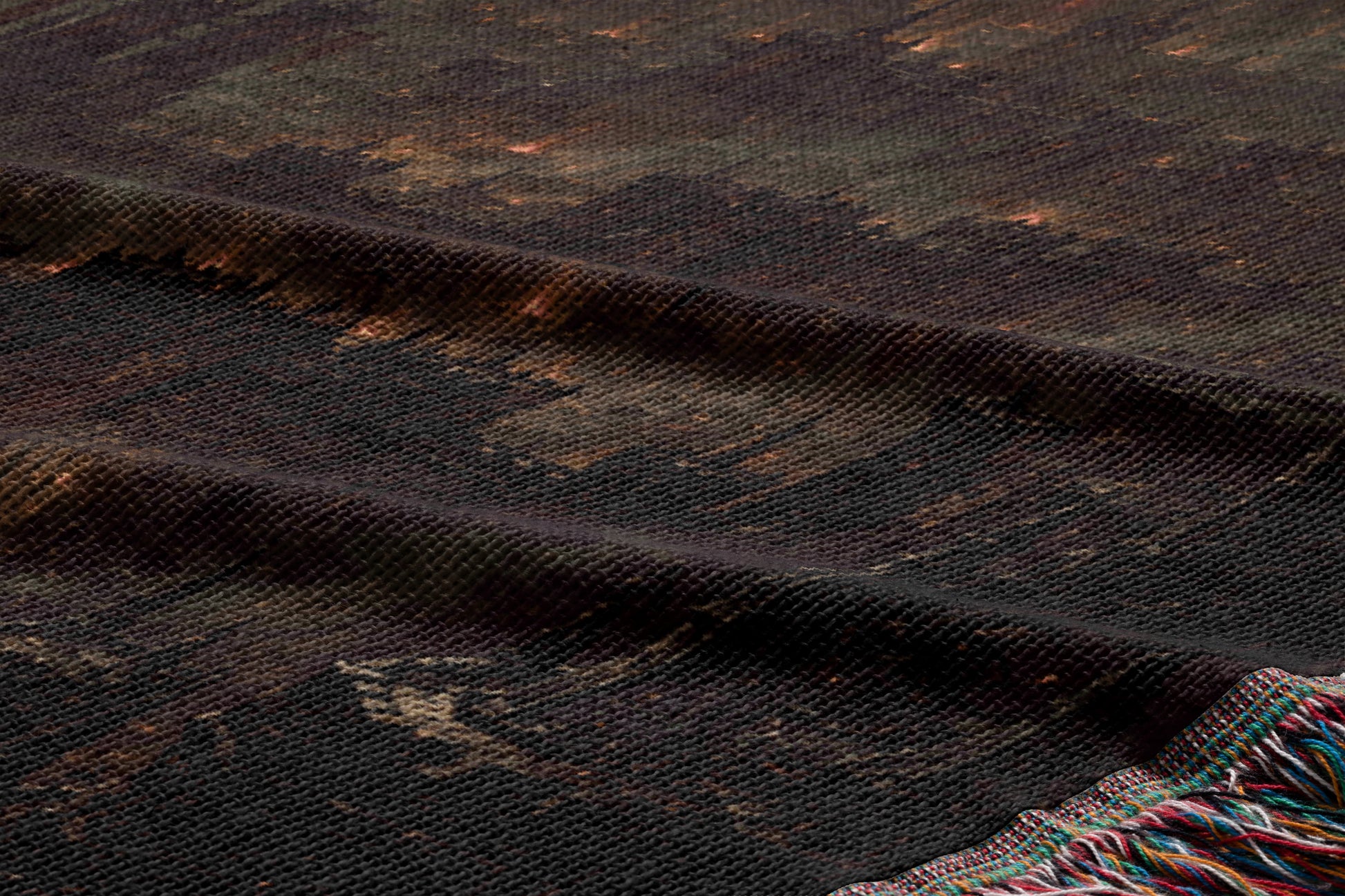a close-up view of a dark, textured fabric with a pattern resembling a city skyline. The fabric appears to be made of a woven material, with a dark brown or black color. The image does not contain any text or other discernible objects or actions.