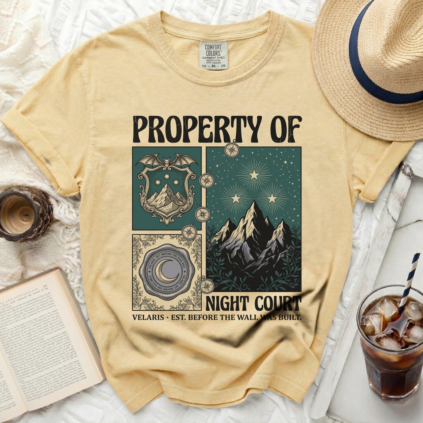 Yellow t-shirt with "PROPERTY OF NIGHT COURT" and illustrated design elements.