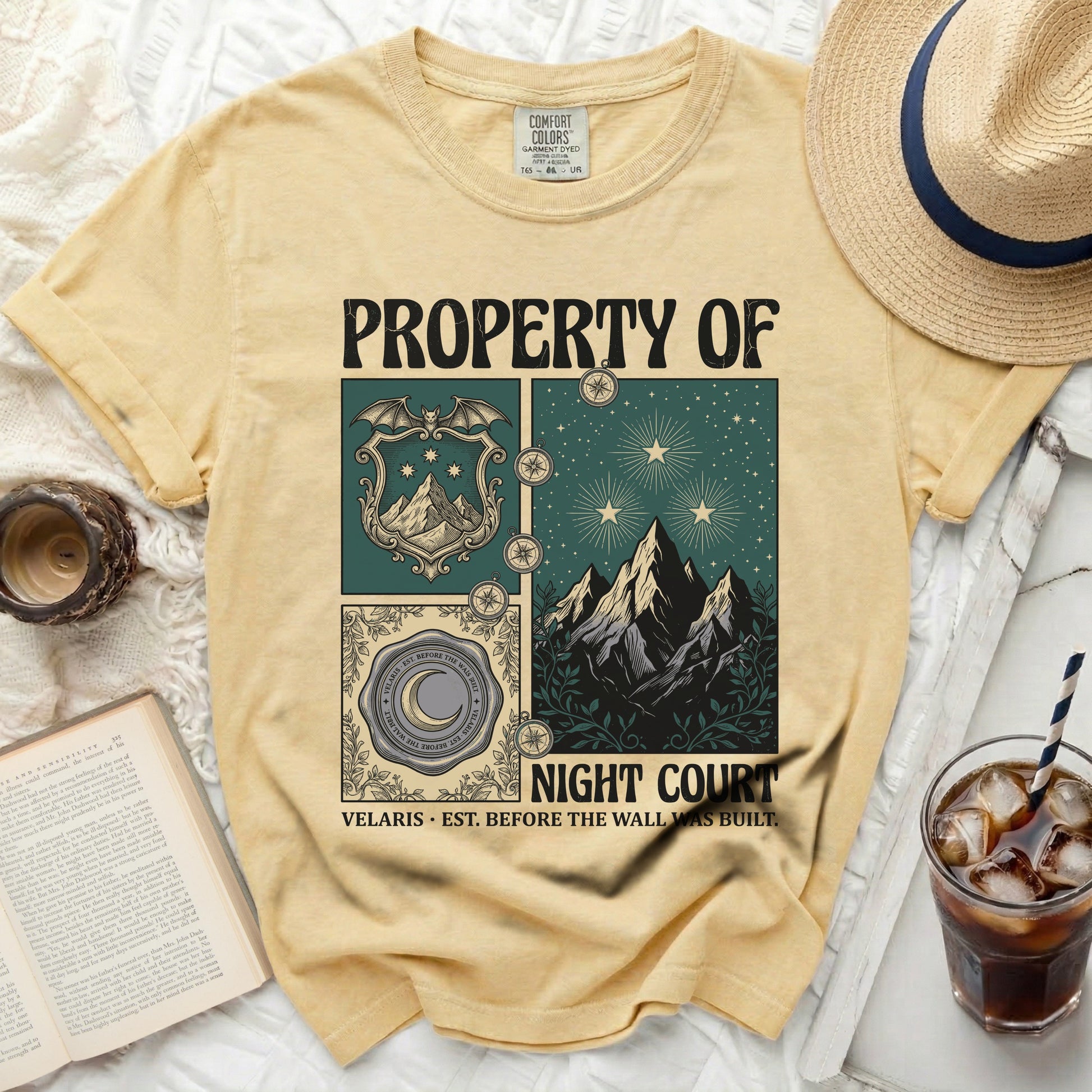Yellow t-shirt with "PROPERTY OF NIGHT COURT" and illustrated design elements.