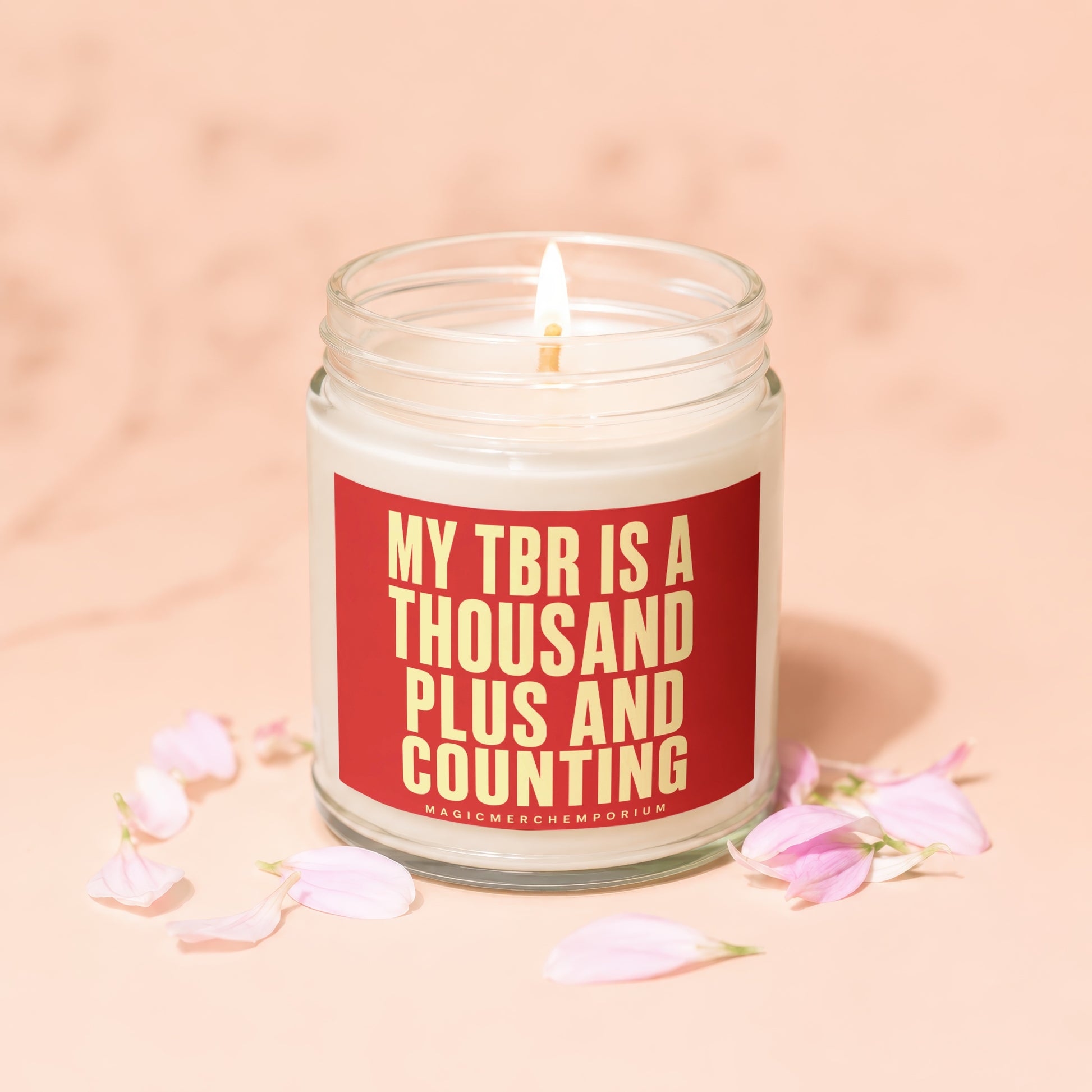 Lit candle in jar with red label: My TBR is a thousand plus and counting.