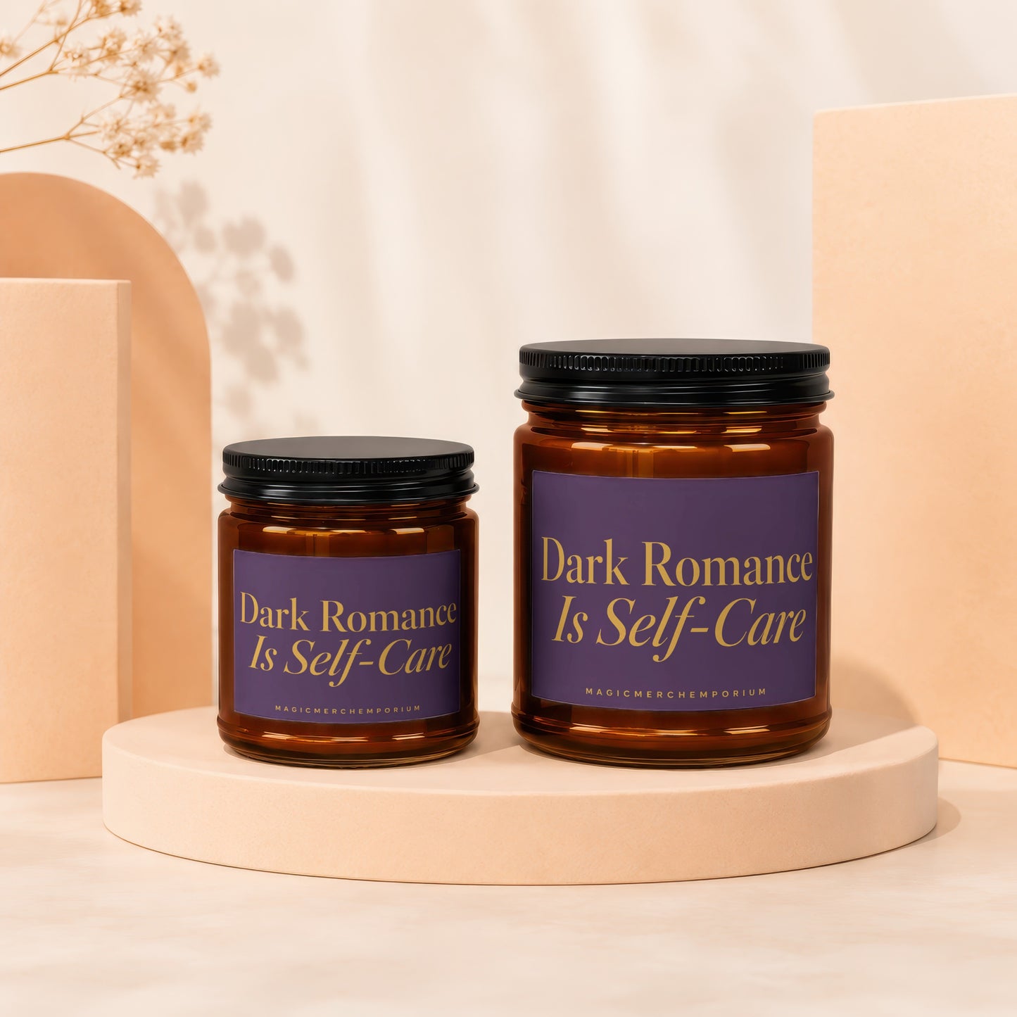 Two amber glass candles with black lids and purple labels reading "Dark Romance Is Self-Care".