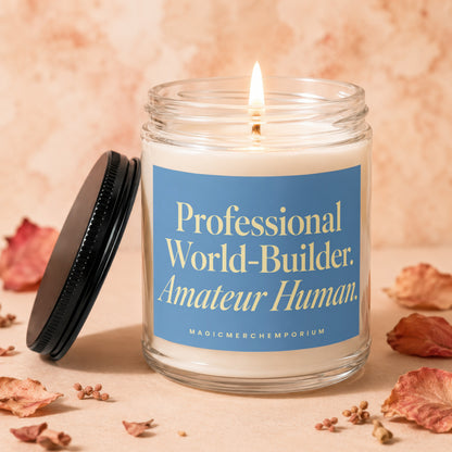 Lit candle with text "Professional World-Builder. Amateur Human." on blue label.