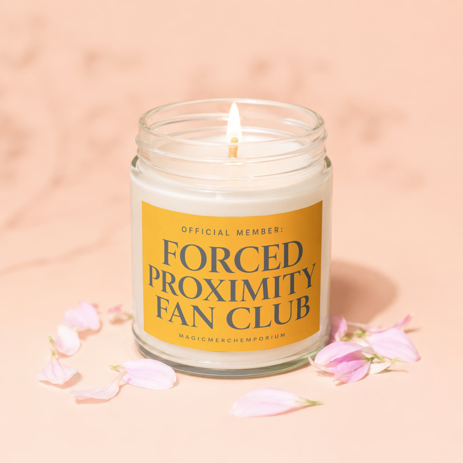 Candle labeled "Official Member: Forced Proximity Fan Club" with lit wick and pink petals.