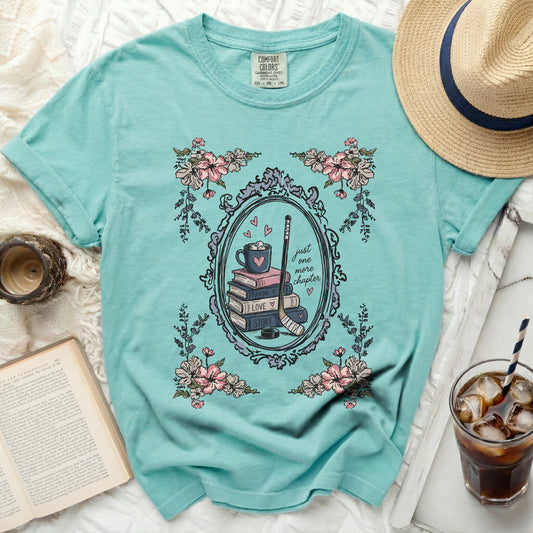 Aqua t-shirt with floral frame, book stack, hockey stick, and text.
