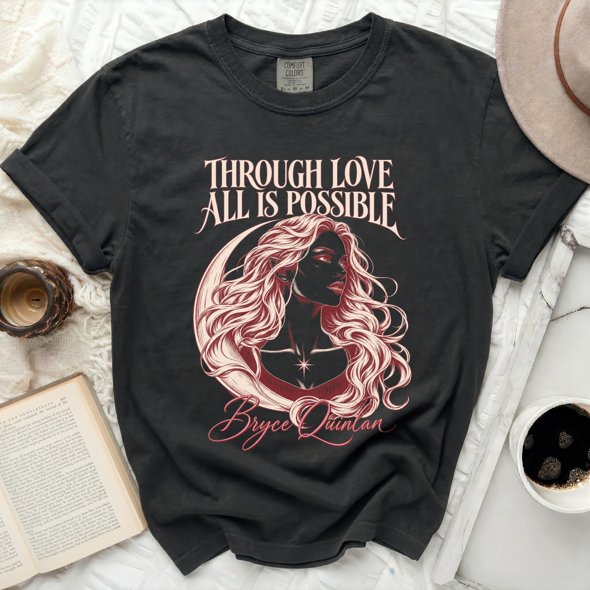 Dark grey t-shirt with "THROUGH LOVE ALL IS POSSIBLE Bryce Quinlan" graphic.