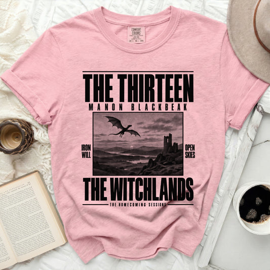 Pink t-shirt with "The Thirteen Manon Blackbeak The Witchlands" text and dragon image.
