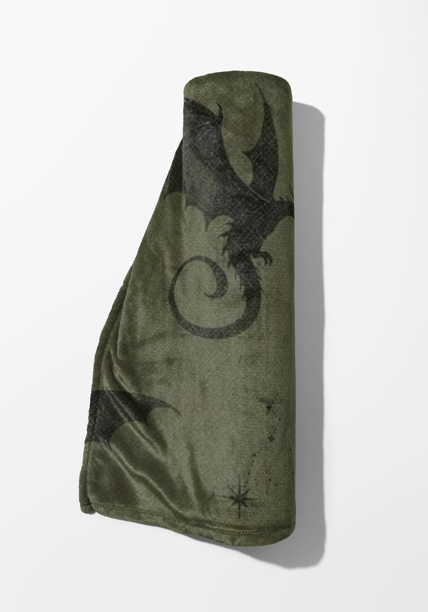Rolled green fleece blanket with black dragon and star pattern.