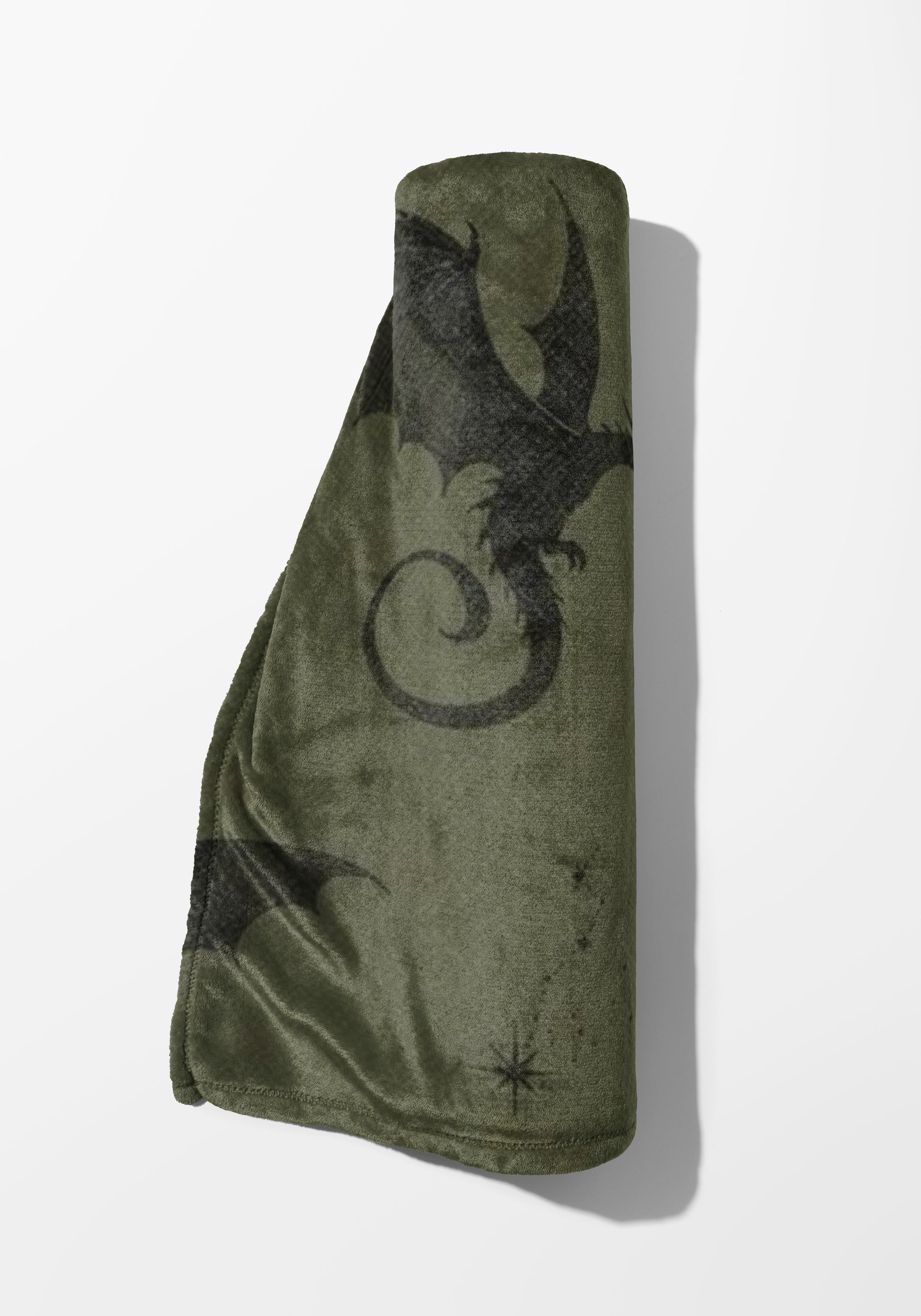 Rolled green fleece blanket with black dragon and star pattern.