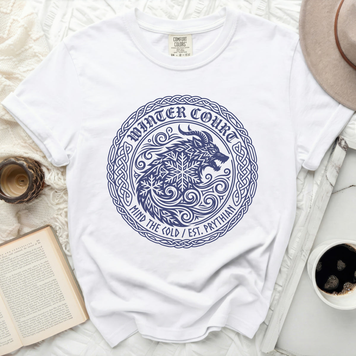 White t-shirt with a navy blue "Winter Court Mind the Cold" graphic of a wolf.