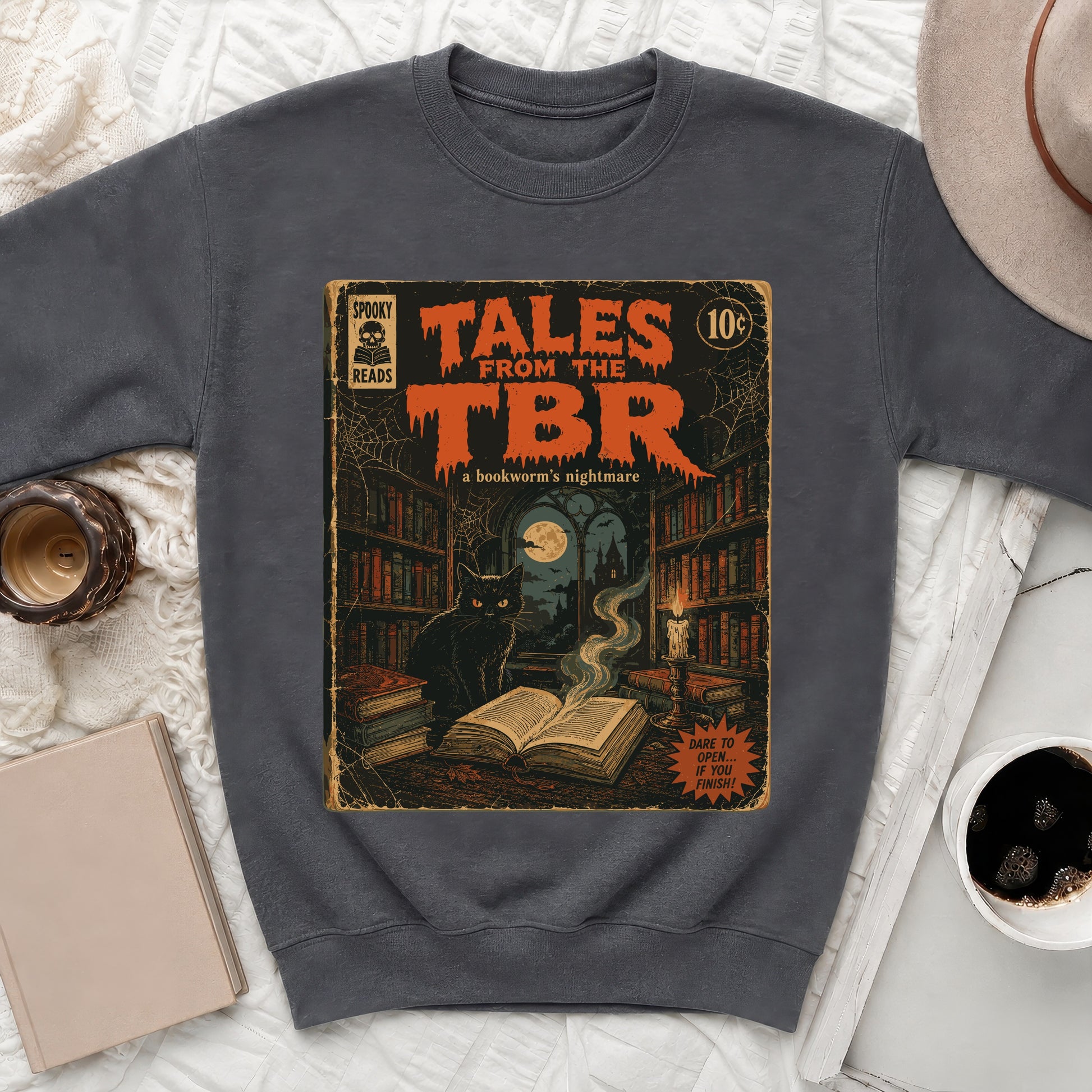 Dark grey crewneck sweatshirt with "Tales From The TBR: A bookworm's nightmare" comic book graphic.