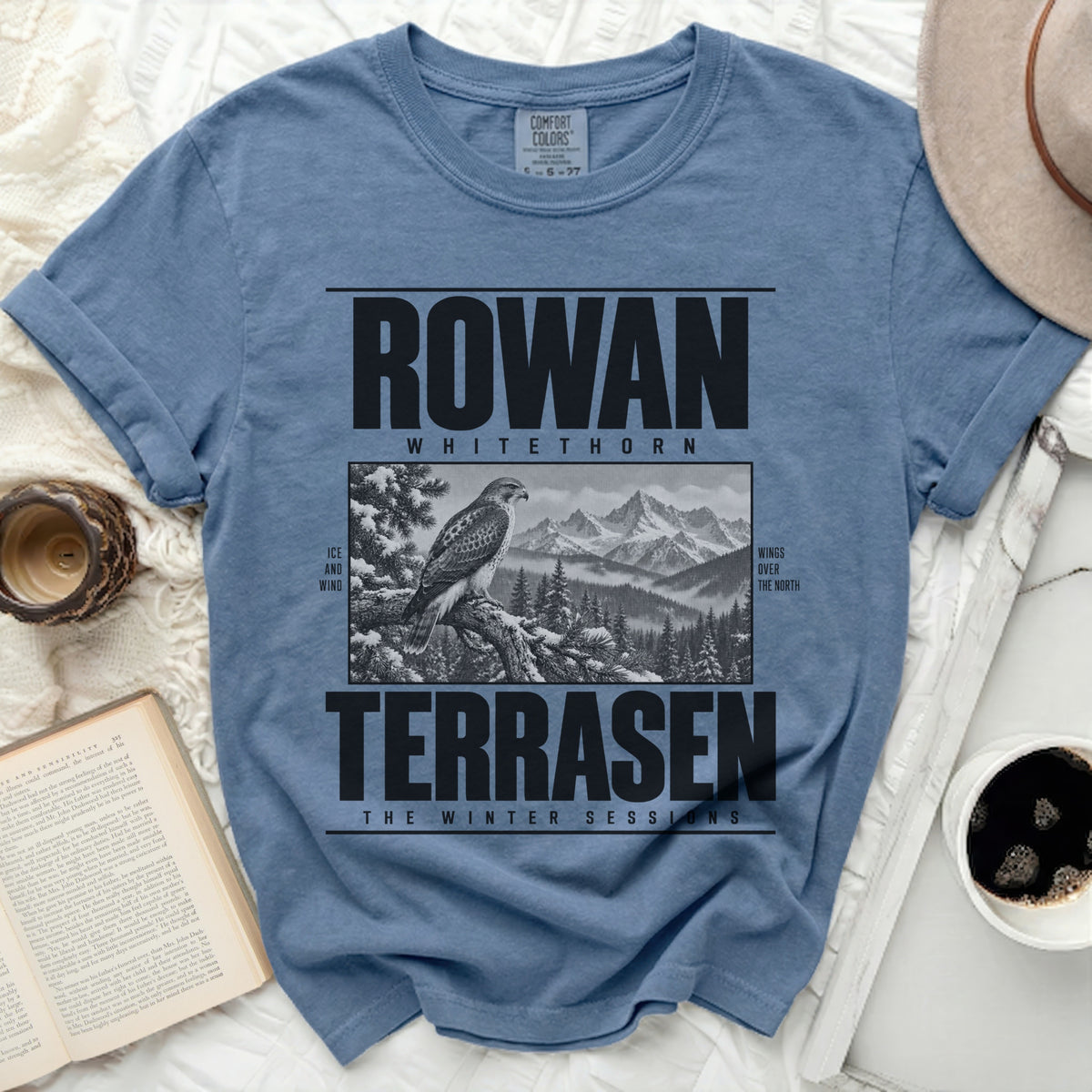 Blue t-shirt with "ROWAN WHITETHORN TERRAsen THE WINTER SESSIONS" and a hawk illustration.