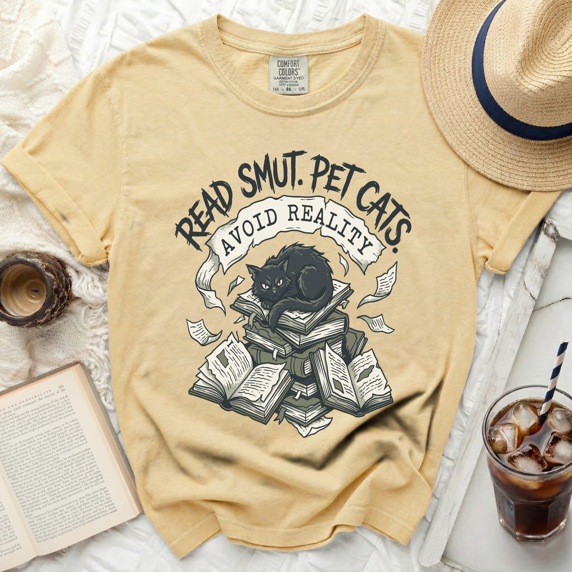 Yellow t-shirt with "Read Smut. Pet Cats. Avoid Reality." graphic.
