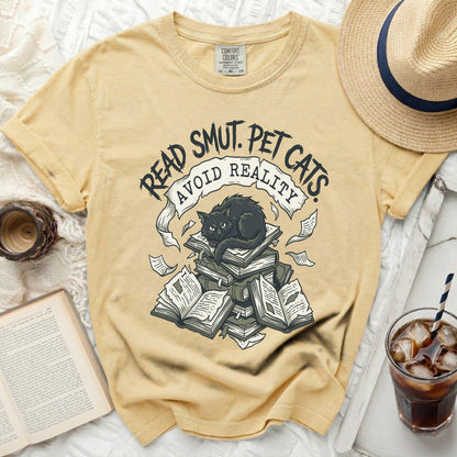 Yellow t-shirt with "Read Smut. Pet Cats. Avoid Reality." graphic.