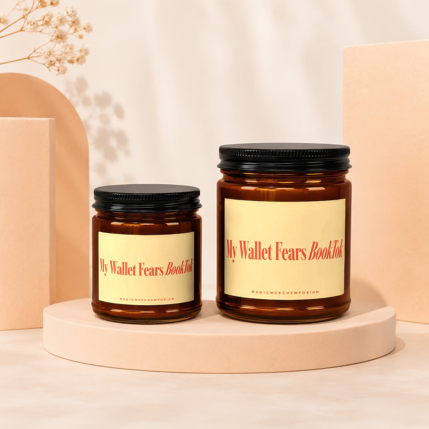 Two amber jars with black lids, one larger than the other.