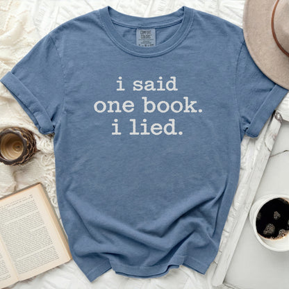 Blue t-shirt with white text: "i said one book. i lied."
