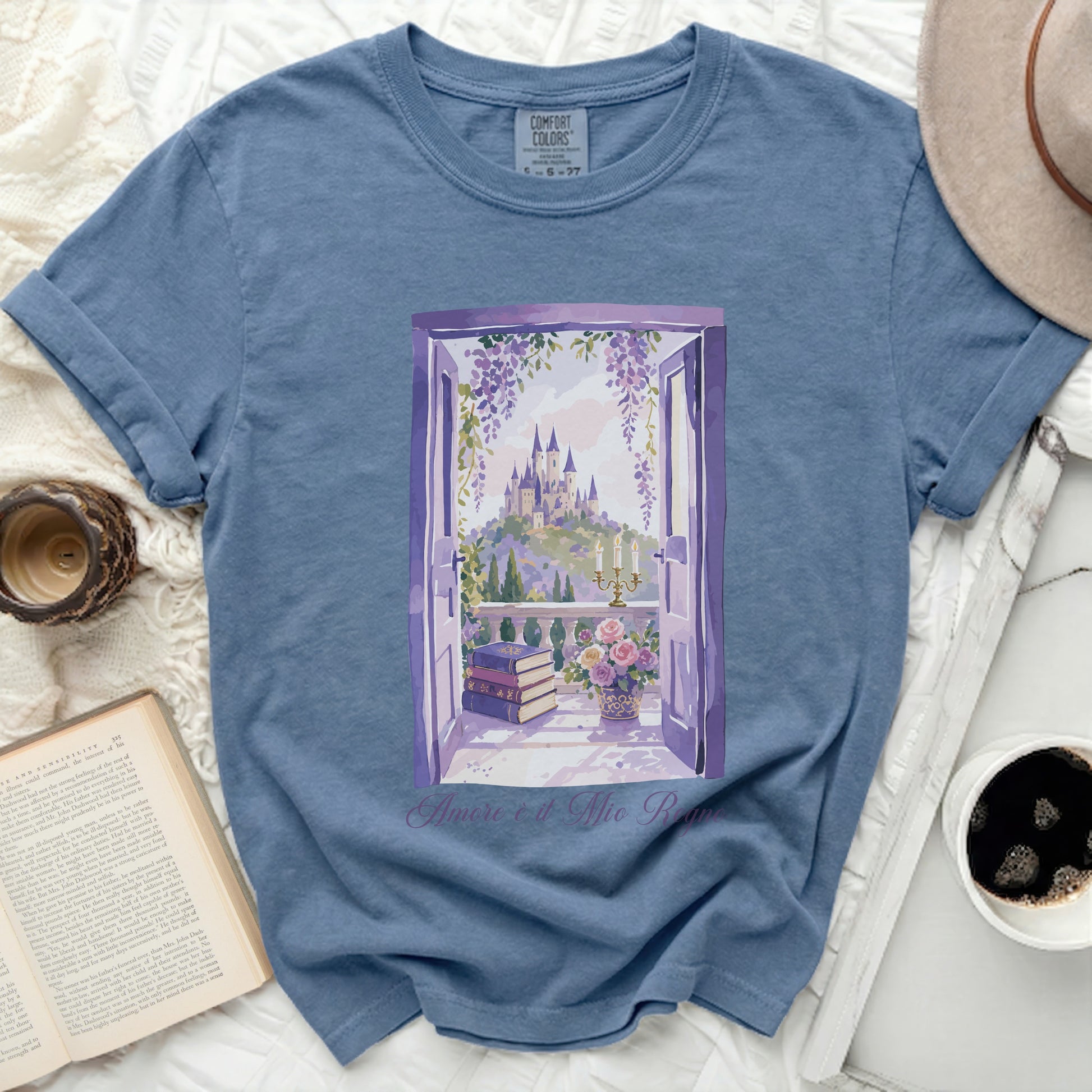 Blue t-shirt with "Amore è il Mio Regno" and castle window scene.