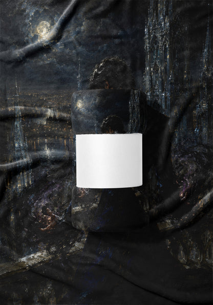 Rolled blanket with a dark, painterly city and moon scene, featuring a white band.