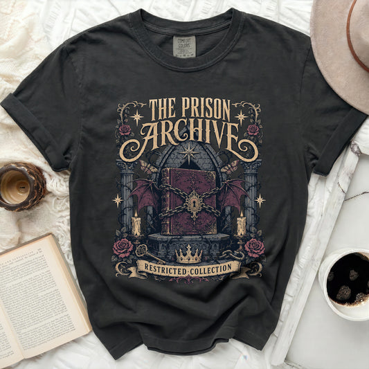 T-shirt with "The Prison Archive Restricted Collection" book graphic.