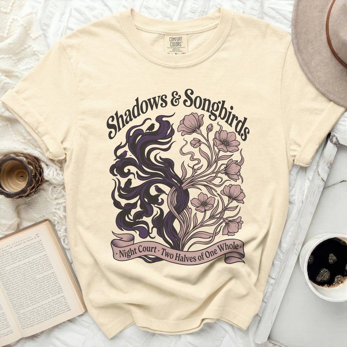 Cream t-shirt with "Shadows & Songbirds" text and floral/shadow design.