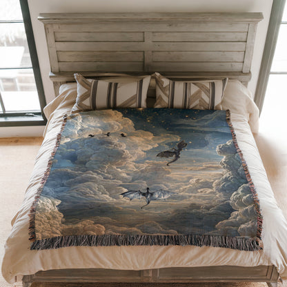 a bedroom with a bed covered in a large, colorful blanket featuring a dragon and clouds. The bed is positioned against a white wall, and there are two pillows on the bed.