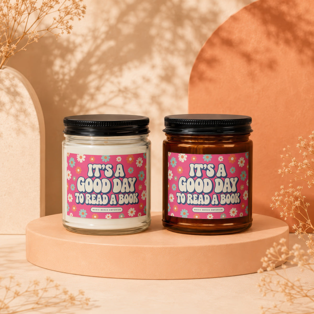 Two candles with "It's a good day to read a book" text on floral labels.