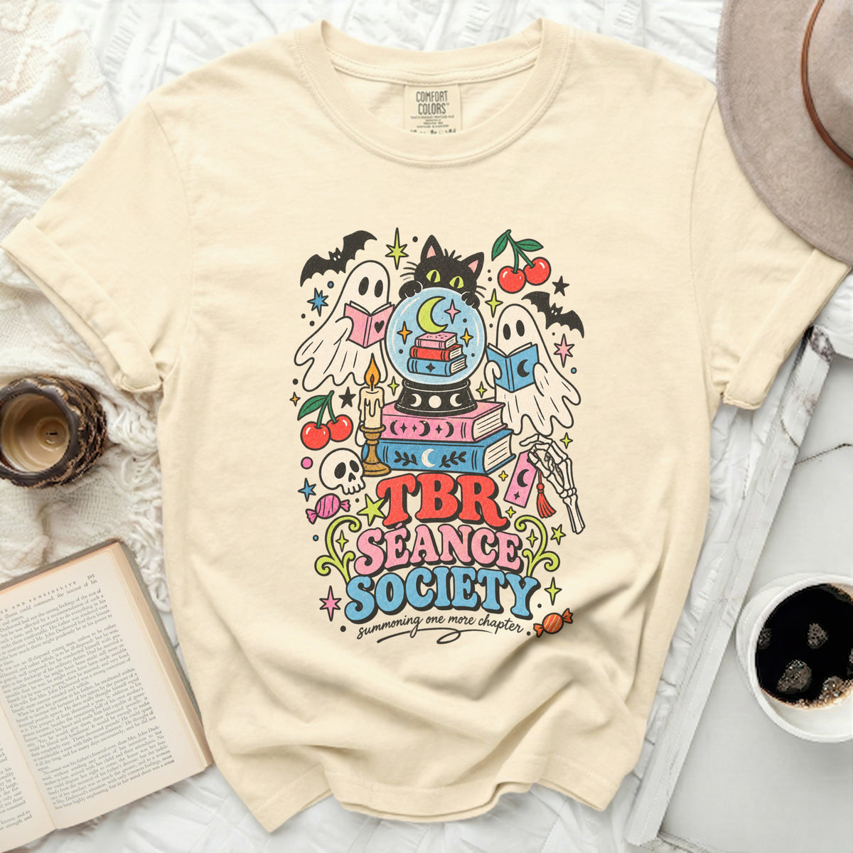 Cream t-shirt with "TBR Seance Society summoning one more chapter" graphic.