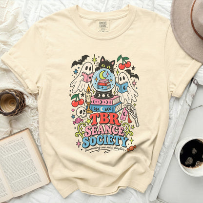 Cream t-shirt with "TBR Seance Society summoning one more chapter" graphic.