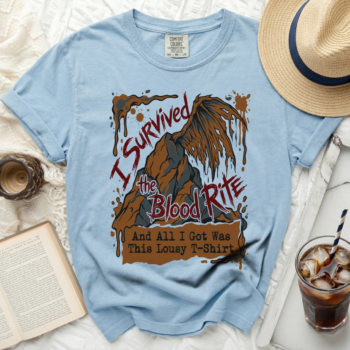Light blue t-shirt with "I Survived the Blood Rite And All I Got Was This Lousy T-Shirt" graphic.