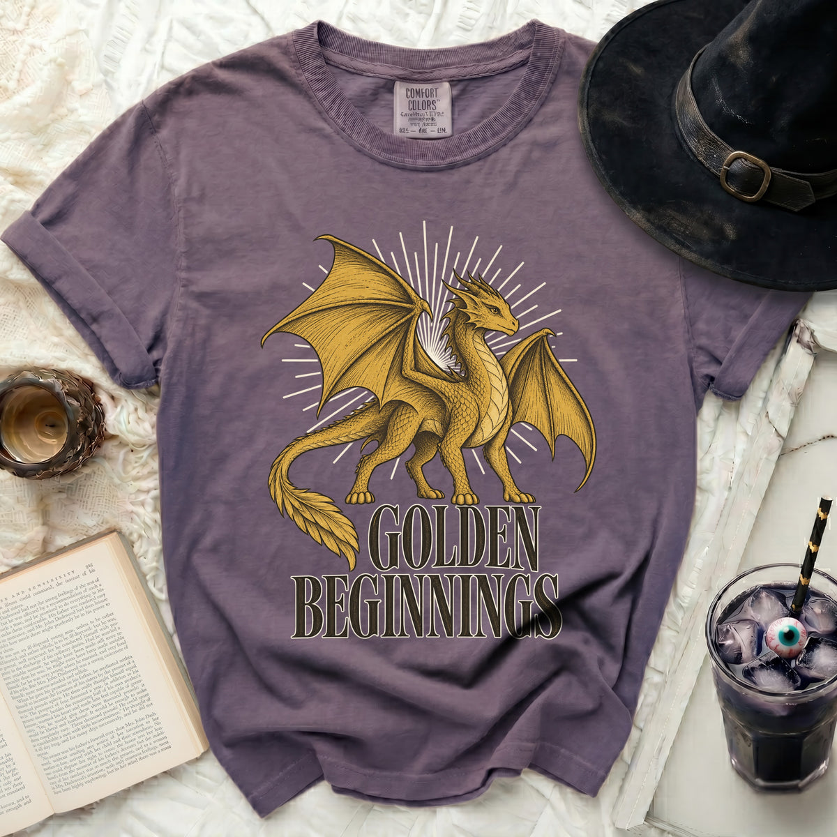 Purple t-shirt with golden dragon graphic and "GOLDEN BEGINNINGS" text.