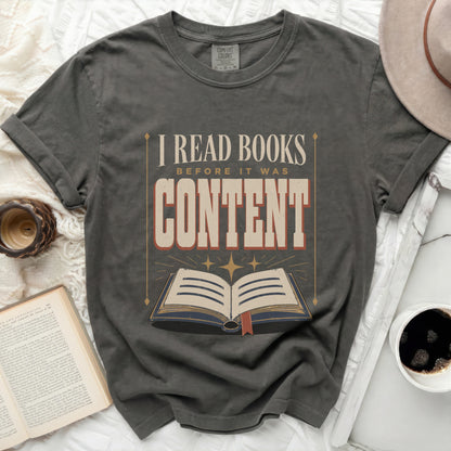 "I Read Books Before It Was Content" graphic t-shirt with open book design.