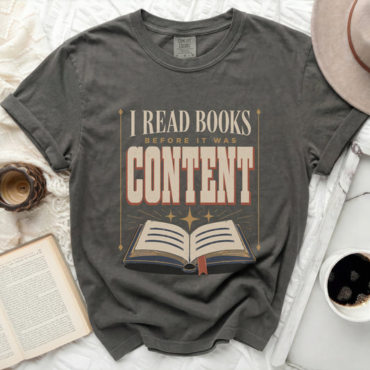 "I Read Books Before It Was Content" graphic t-shirt with open book design.