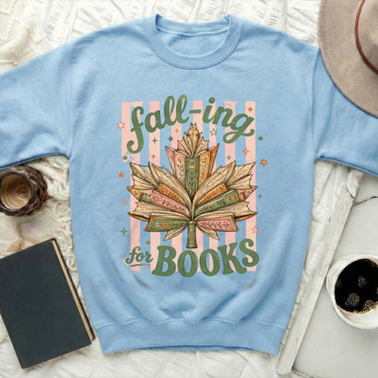 Light blue sweatshirt with "fall-ing for Books" text and a book-shaped leaf design.