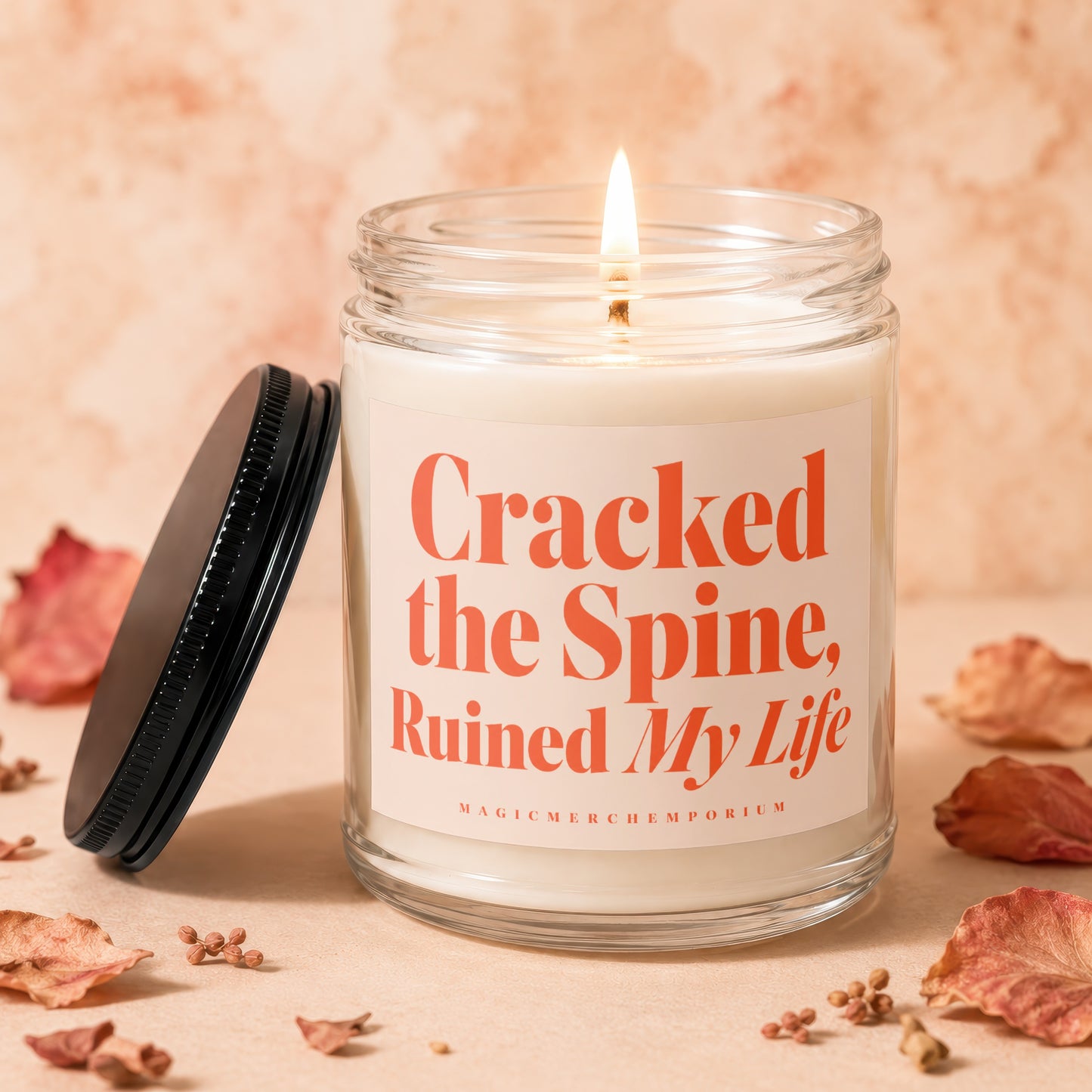 Candle with text "Cracked the Spine, Ruined My Life" and "MAGICMERCH...emporium".