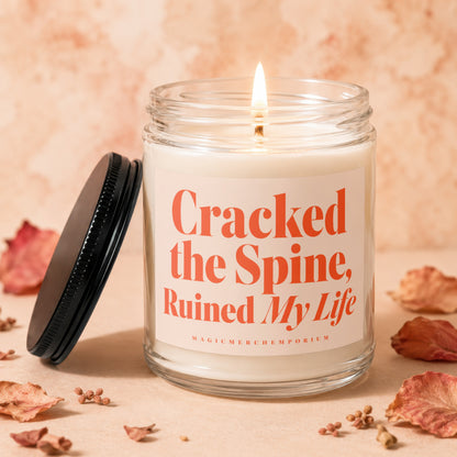 Candle with text "Cracked the Spine, Ruined My Life" and "MAGICMERCH...emporium".