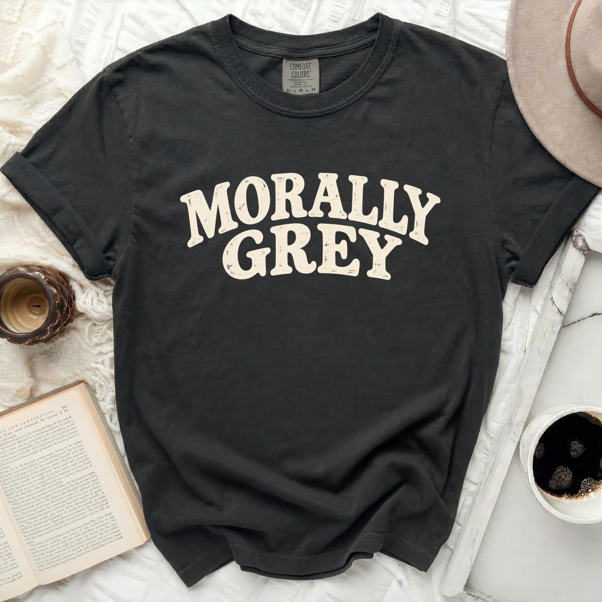 Dark grey t-shirt with "Morally Grey" in distressed cream lettering.