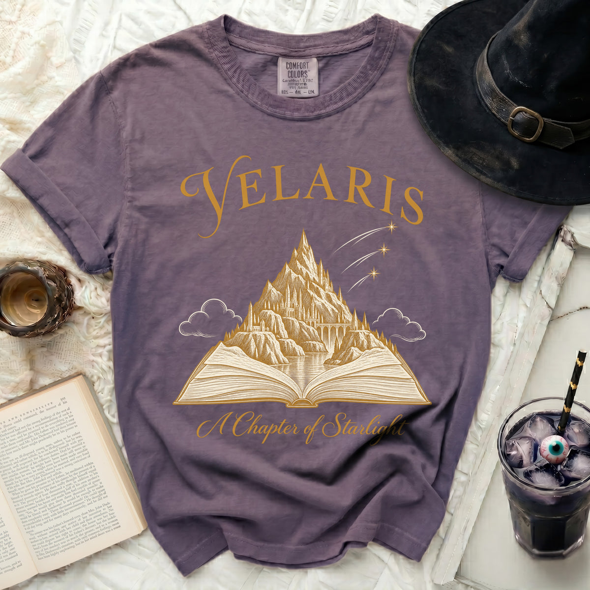 Purple t-shirt with "Velaris A Chapter of Starlight" and a castle on an open book.