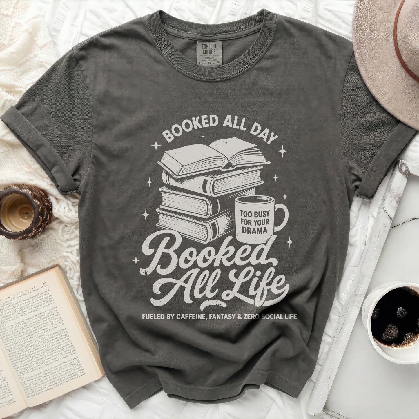Graphic tee with books, mug, and text "Booked All Day": "Booked All Life"