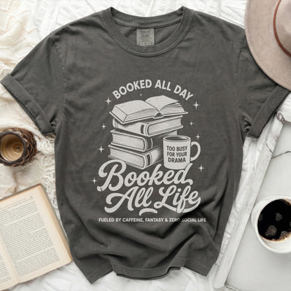 Graphic tee with books, mug, and text "Booked All Day": "Booked All Life"