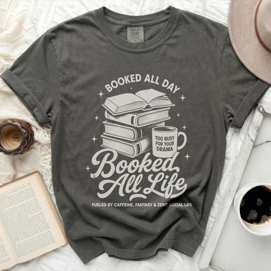 Graphic tee with books, mug, and text "Booked All Day": "Booked All Life"