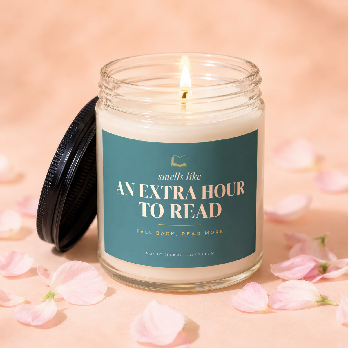 Glass candle with teal label reading "smells like AN EXTRA HOUR TO READ".