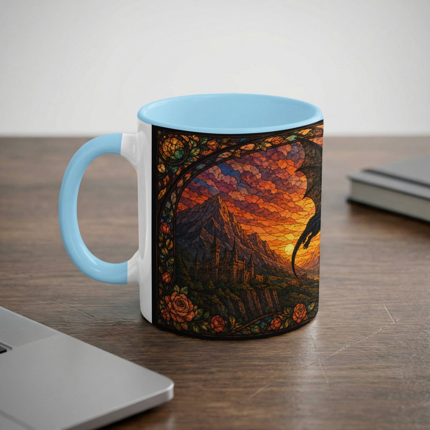 White mug with light blue handle featuring stained glass art of a dragon over a castle at sunset.