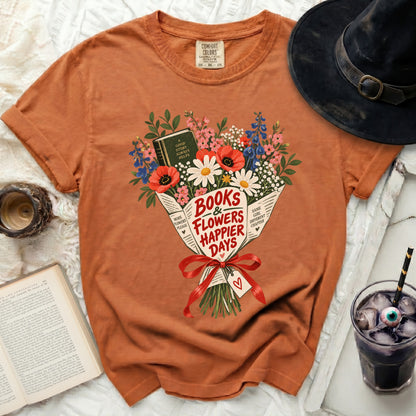Orange t-shirt with "Books & Flowers Happier Days" floral graphic.