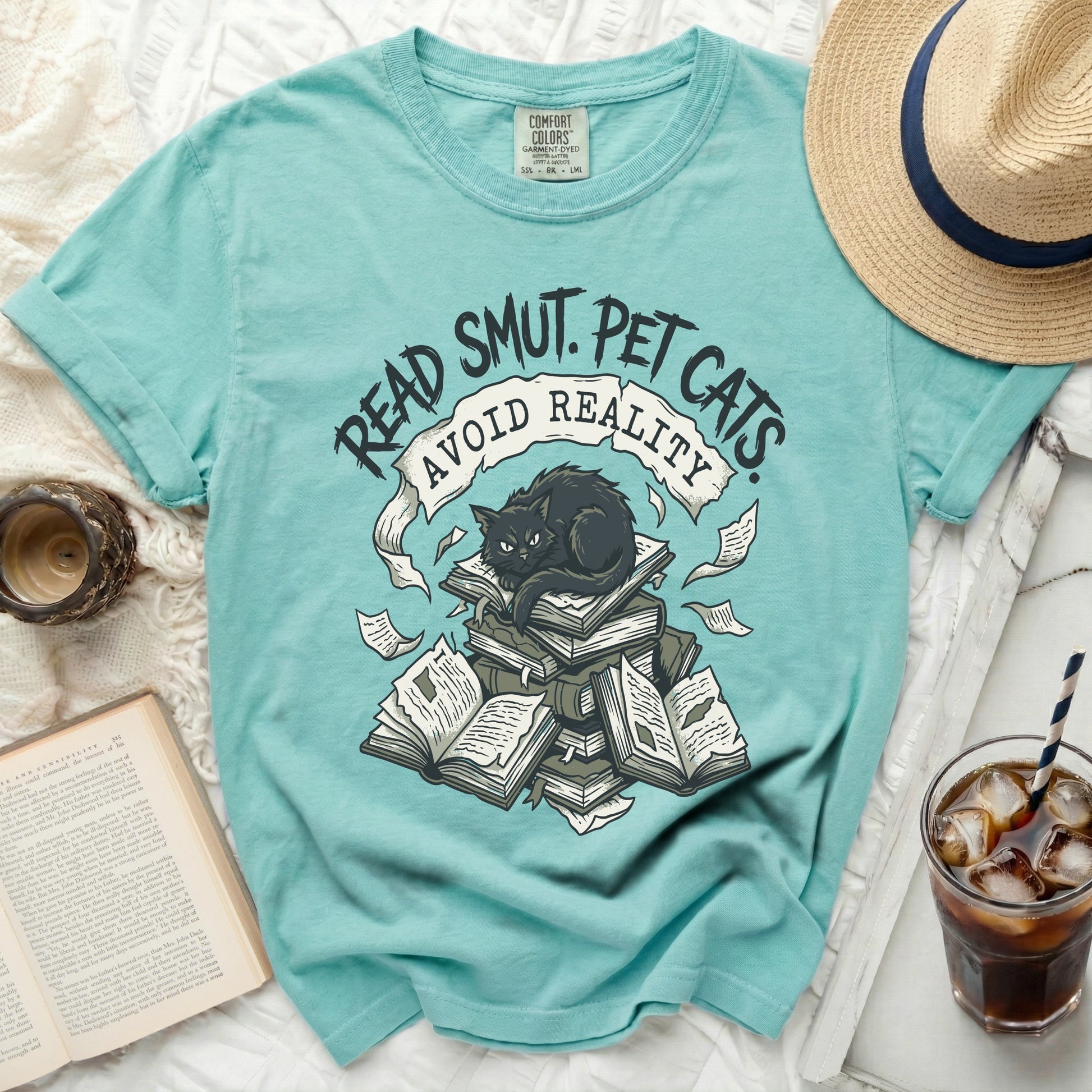Aqua t-shirt with "Read Smut, Pet Cats, Avoid Reality" and a black cat on books.