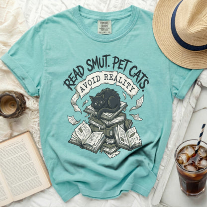 Aqua t-shirt with "Read Smut, Pet Cats, Avoid Reality" and a black cat on books.